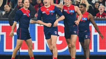 Bayley Fritsch (2nd left) kicked a goal of the year contender as the Demons toppled the Cats. (Morgan Hancock/AAP PHOTOS)